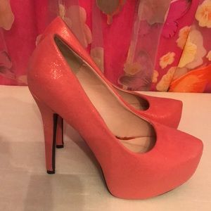 Coral/pinkish platform pumps.